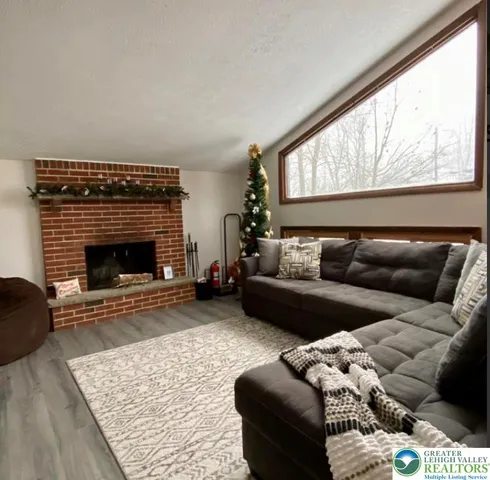 a living room with furniture a rug and a fireplace