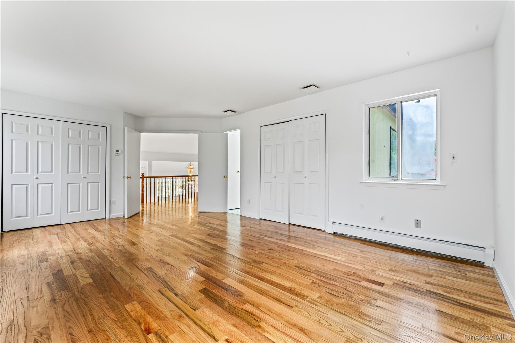 126 Bagatelle Road Melville, NY 11747 - Photo 29 of 50 a view of empty room with wooden floor and windows