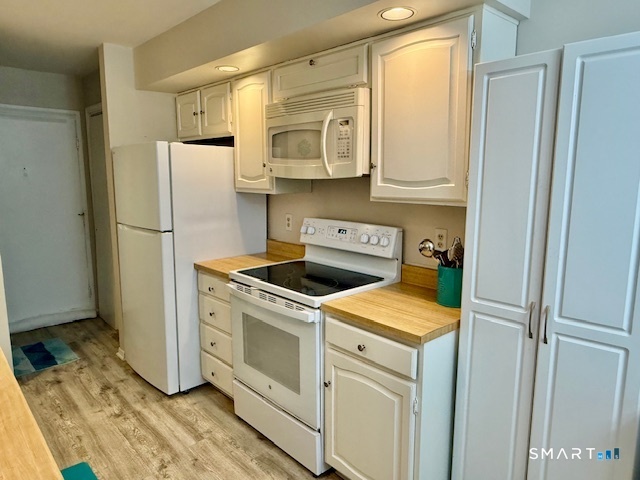 4 Arlington Court, Unit 4 Brookfield, CT 06804 - Photo 6 of 21 a kitchen with a refrigerator sink and cabinets