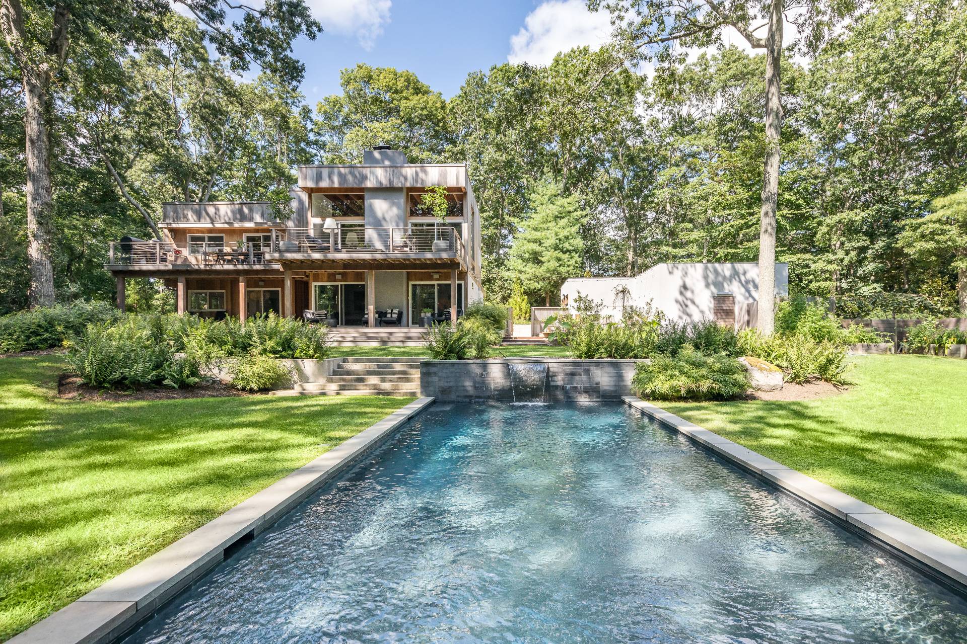 a front view of a house with a yard table and chairs