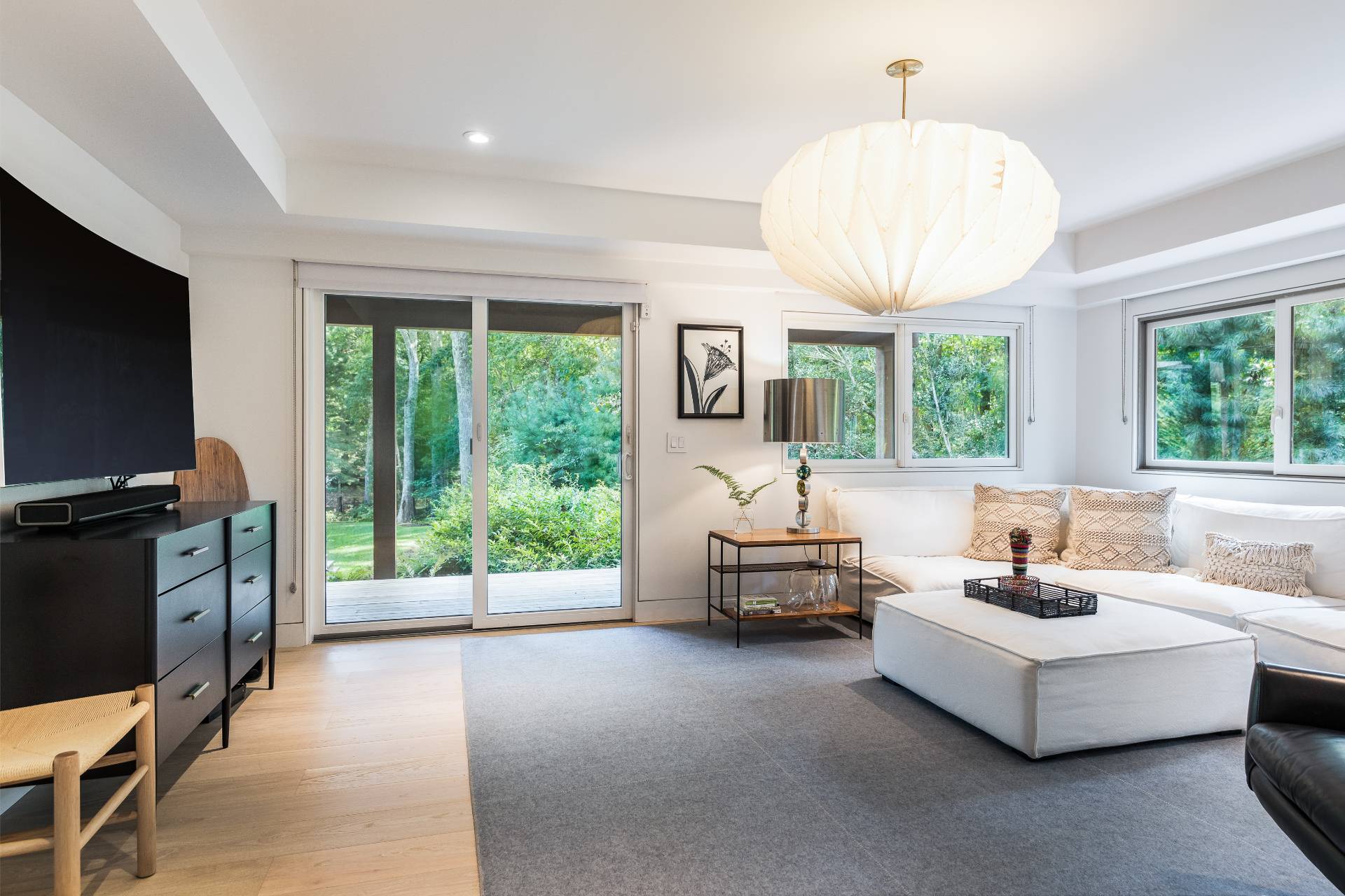 216 Bull Path East Hampton, NY 11937 - Photo 23 of 30 a living room with furniture a flat screen tv and a large window