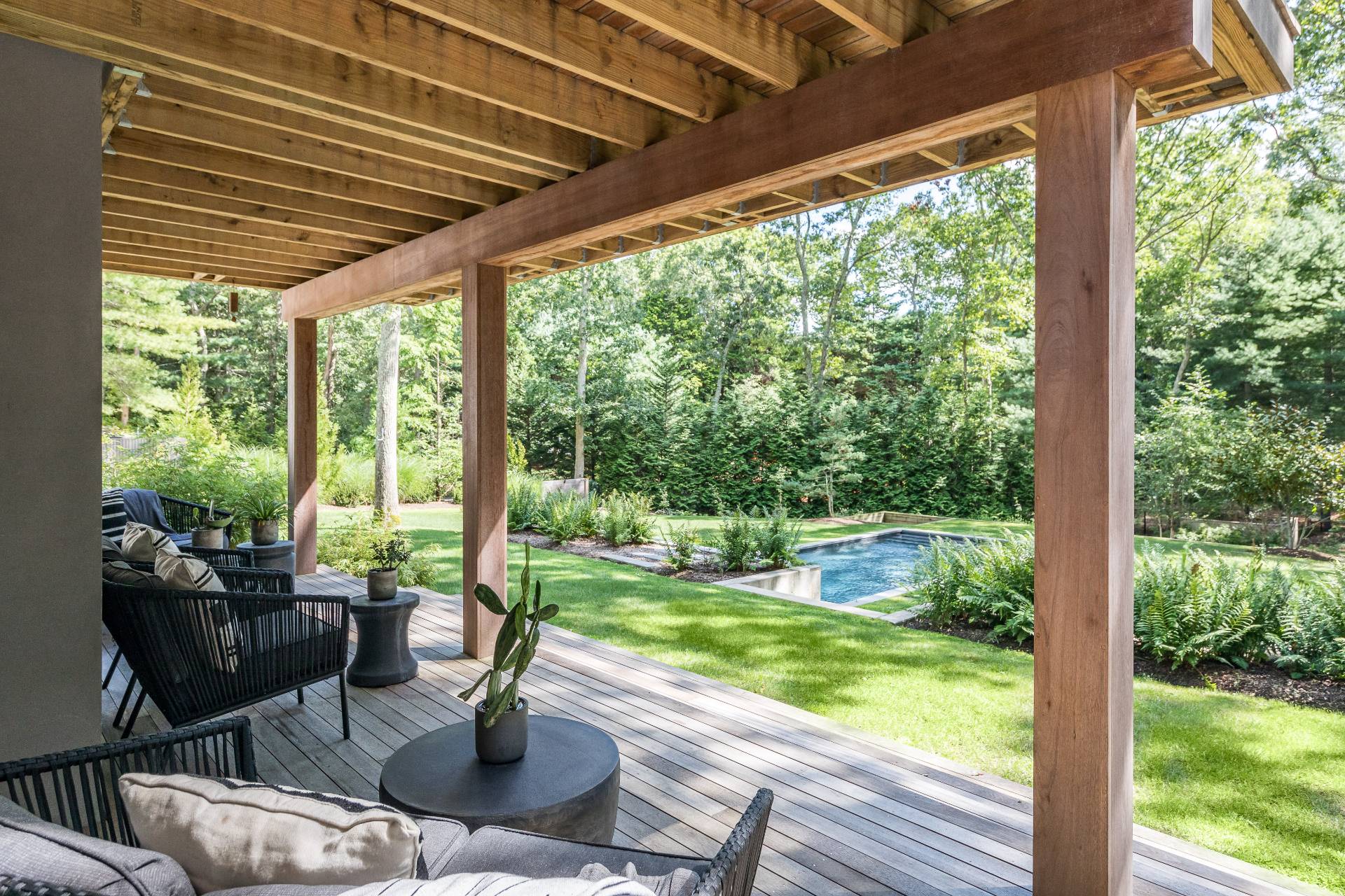 216 Bull Path East Hampton, NY 11937 - Photo 28 of 30 a patio with yard glass top table and chairs
