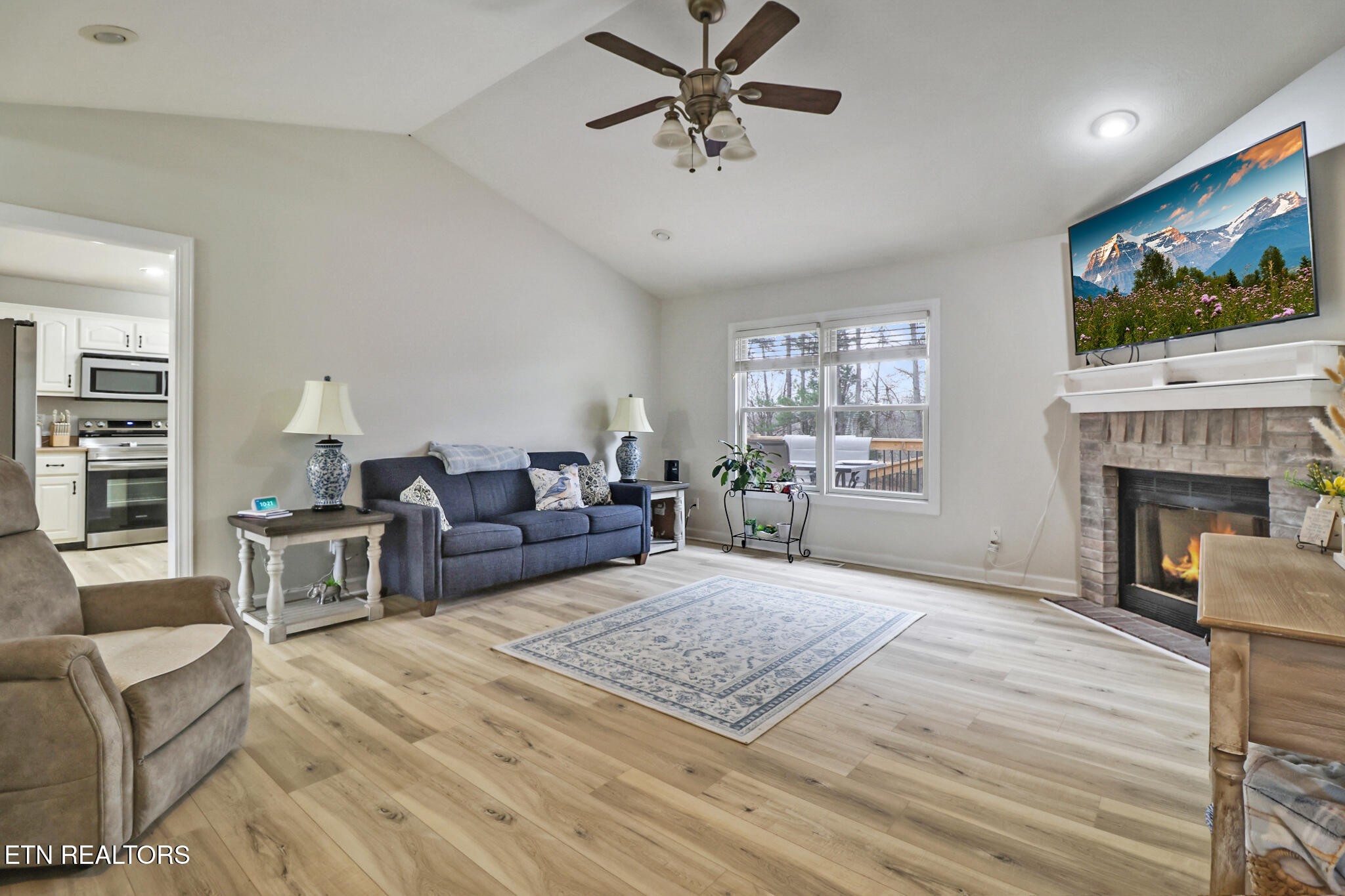 93 Tower Way Allardt, TN 38504 - Photo 12 of 40 a living room with furniture a flat screen tv and a fireplace