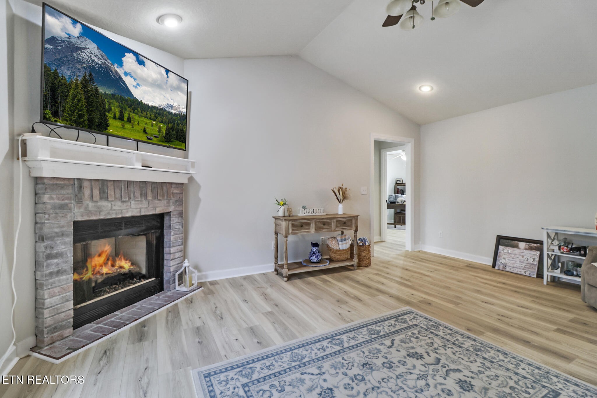 93 Tower Way Allardt, TN 38504 - Photo 14 of 40 a living room with furniture a flat screen tv and a fireplace