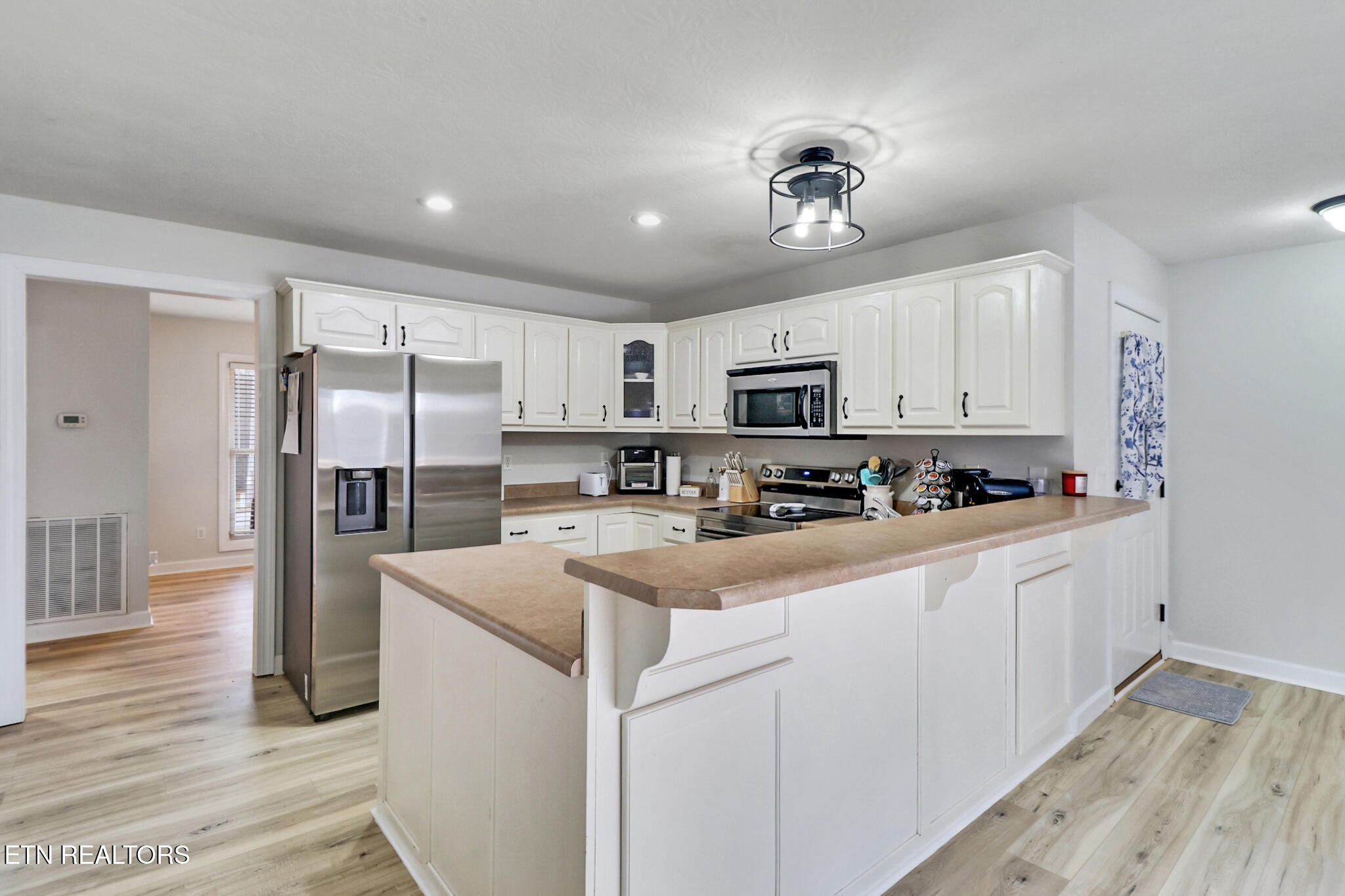 93 Tower Way Allardt, TN 38504 - Photo 21 of 40 a kitchen with stainless steel appliances granite countertop a refrigerator and a stove top oven
