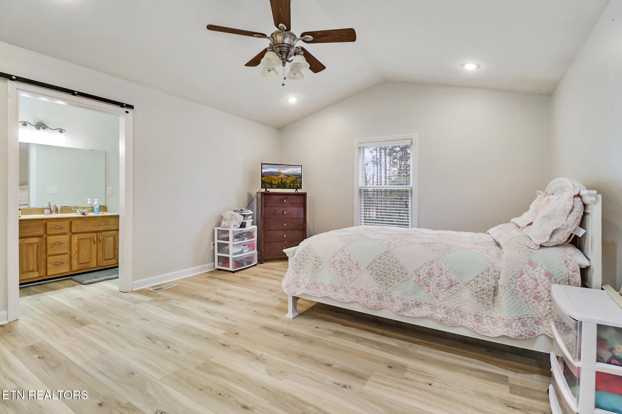 93 Tower Way Allardt, TN 38504 - Photo 25 of 40 a bedroom with a bed and a chandelier