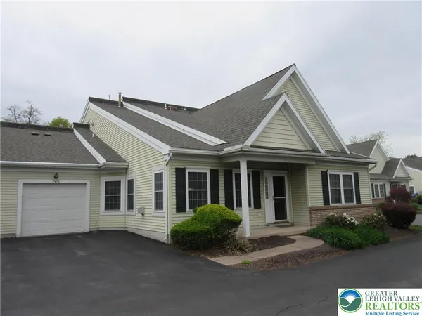 a front view of a house with yard