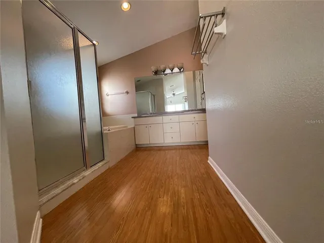 a view of a kitchen from a hallway