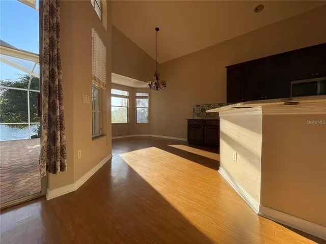 a view of a refrigerator in kitchen and wooden floor