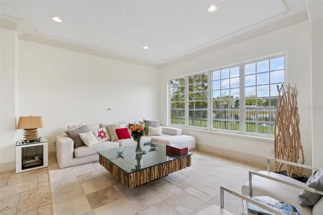 a view of a dining room with furniture a chandelier and wooden floor