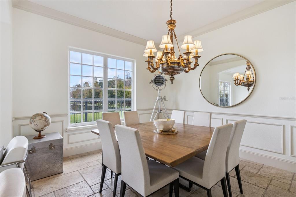 103 Acadia Terrace Celebration, FL 34747 - Photo 12 of 87 a view of a dining room with furniture a chandelier and wooden floor