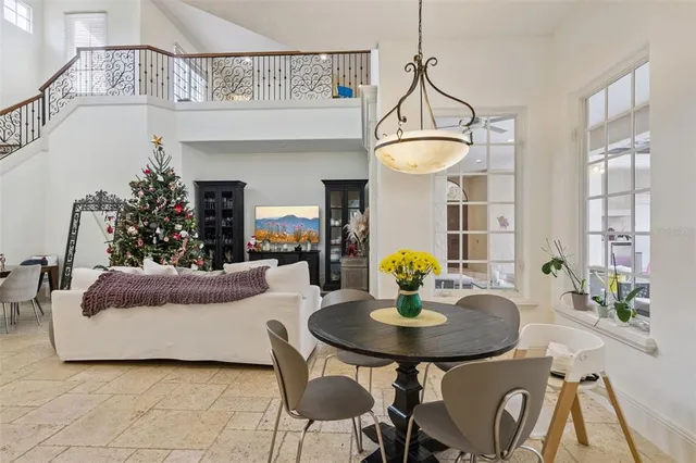 a living room with furniture and flowers