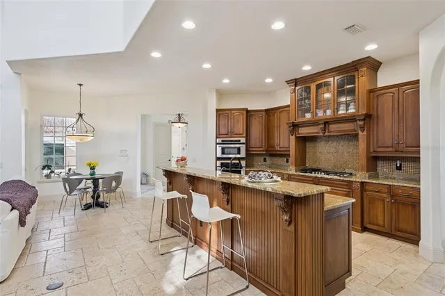 a spacious bathroom with a granite countertop sink a large mirror and a bathtub
