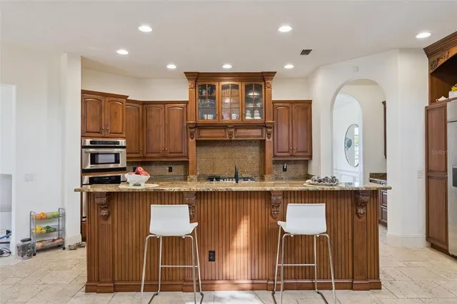a large kitchen with a sink and cabinets