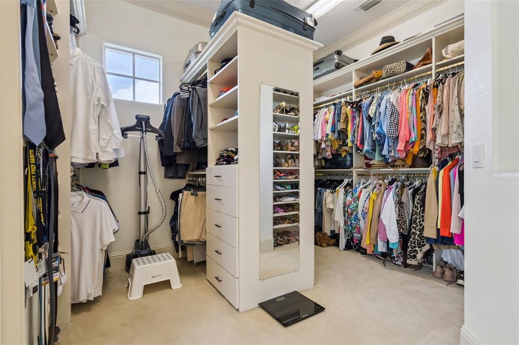 103 Acadia Terrace Celebration, FL 34747 - Photo 34 of 87 a view of walk in closet with clothes and shoes