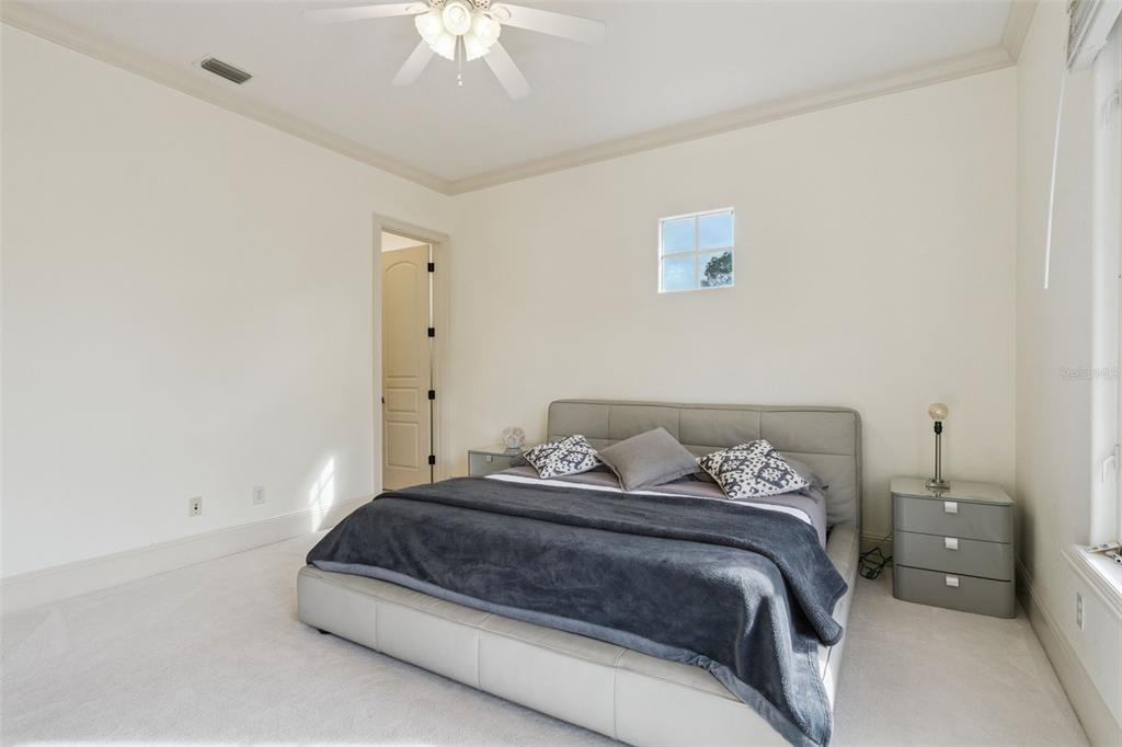 103 Acadia Terrace Celebration, FL 34747 - Photo 36 of 87 a bedroom with a bed and a chandelier