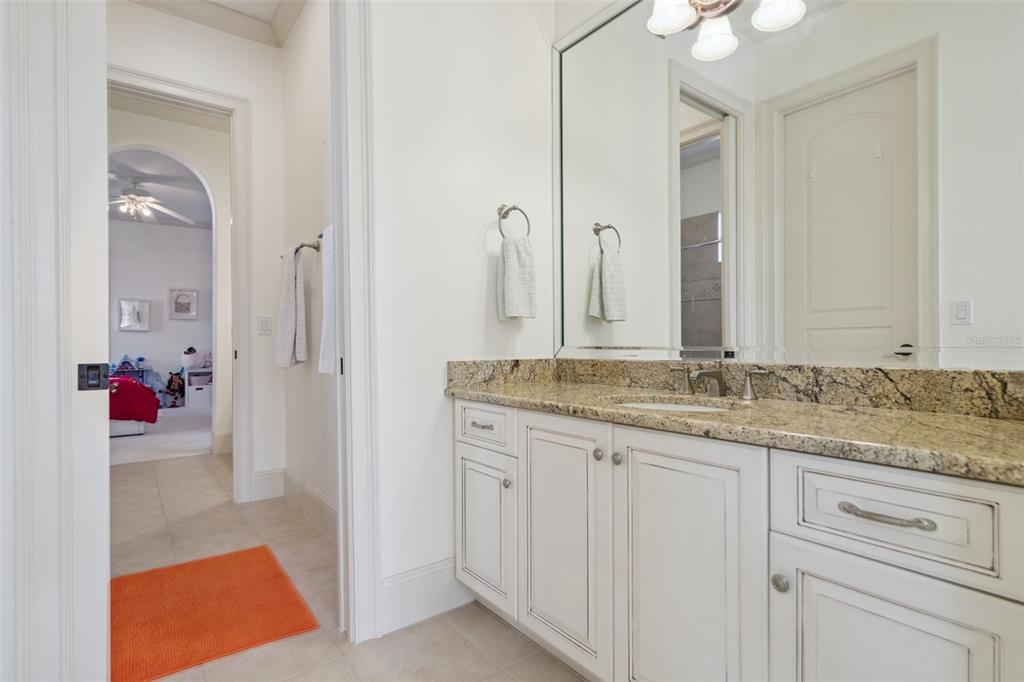 103 Acadia Terrace Celebration, FL 34747 - Photo 45 of 87 a bathroom with a granite countertop sink and a mirror