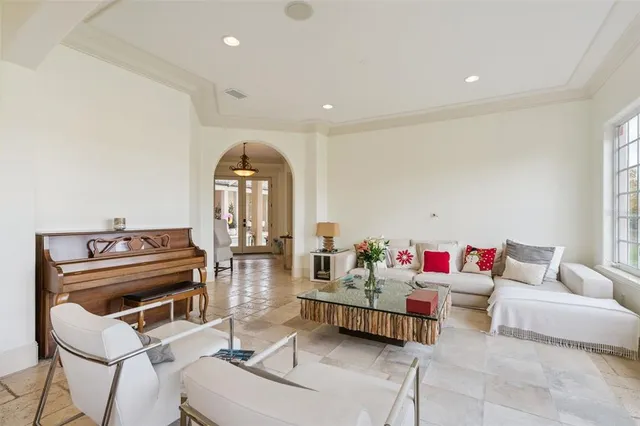 a living room with furniture a chandelier and a rug