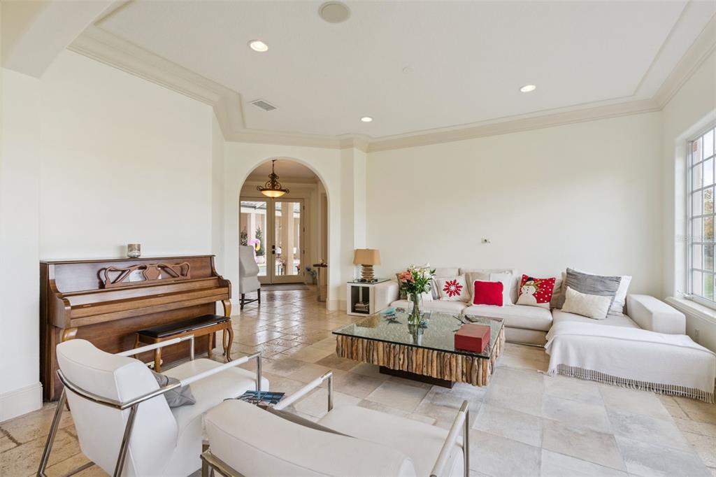 103 Acadia Terrace Celebration, FL 34747 - Photo 7 of 87 a living room with furniture and a chandelier
