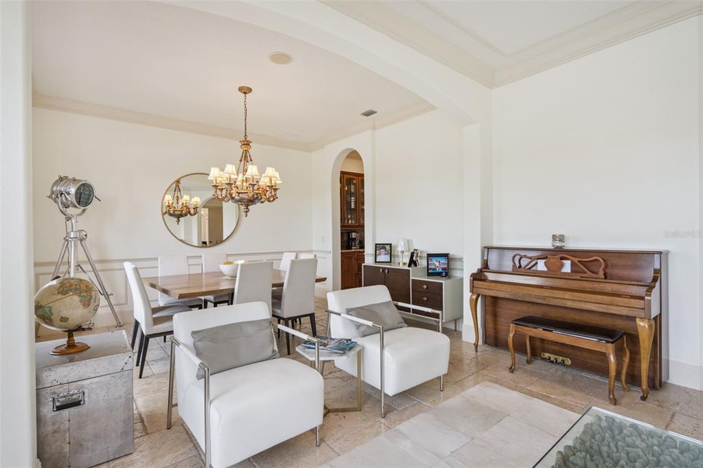 103 Acadia Terrace Celebration, FL 34747 - Photo 8 of 87 a living room with furniture a chandelier and a rug