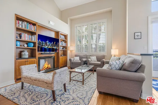 a living room with furniture and a book shelf