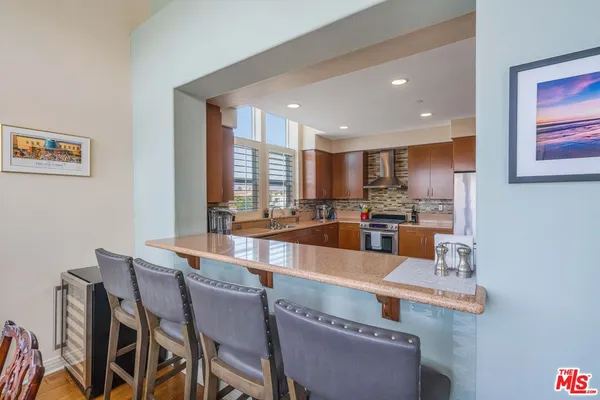 a large kitchen with a table and chairs