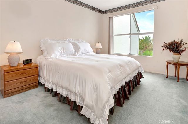 a bed room with a bed and a large window