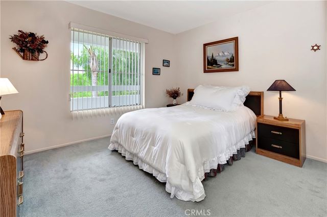 a spacious bedroom with a bed and a window