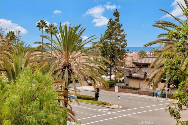 a view of a street with palm trees