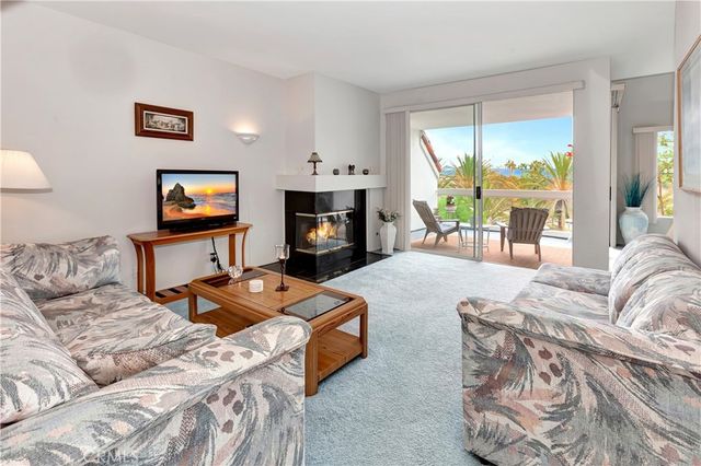 a living room with furniture large window and a fireplace