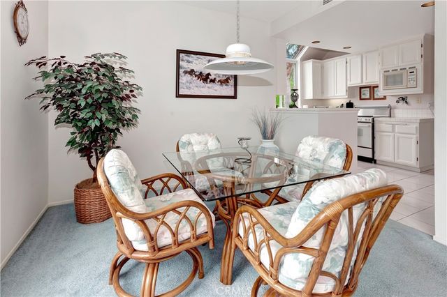 a dining room filled chandelier and wooden floor