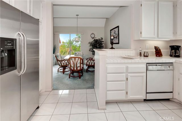 a kitchen with a refrigerator and a sink
