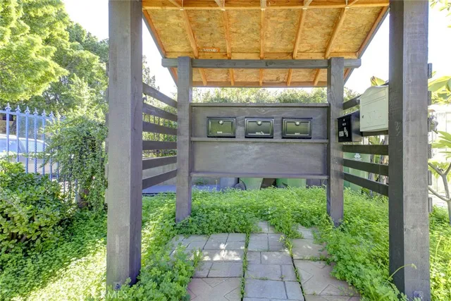 a view of a brick house with a large windows and plants