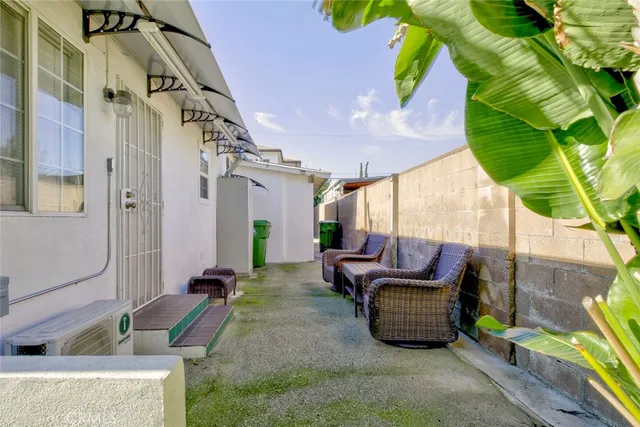 a backyard of a house with outdoor seating