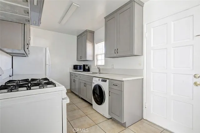 a utility room with sink dryer and washer