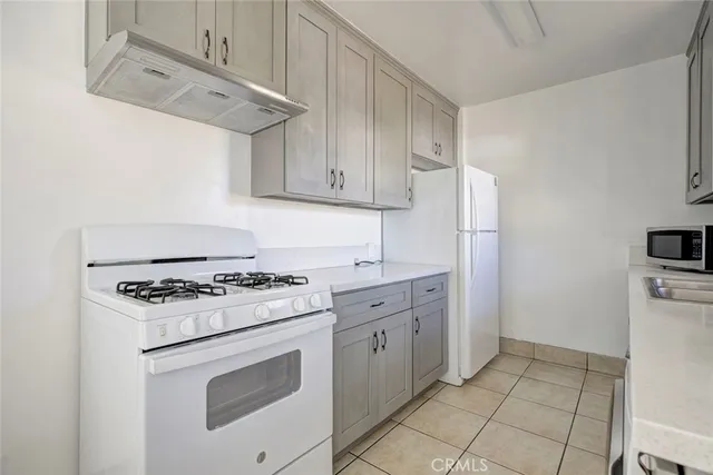 a kitchen with cabinets appliances and a counter top