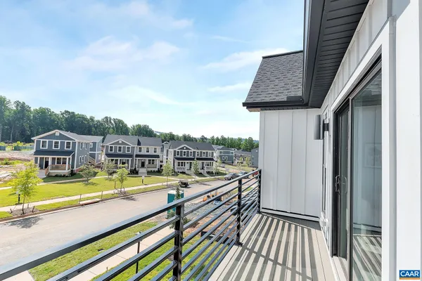 a view of a house with pool and chairs
