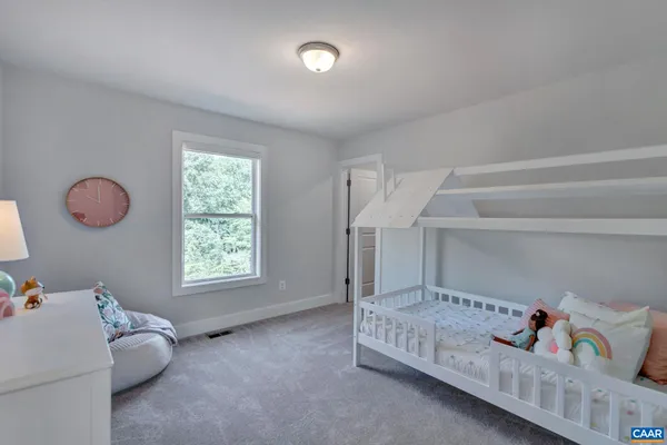 a bedroom with furniture and a window