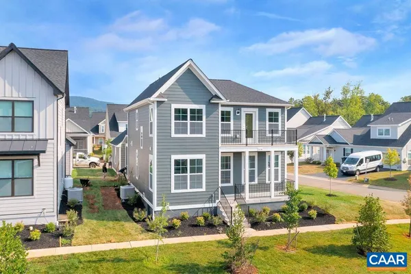 a front view of residential houses with yard and swimming pool