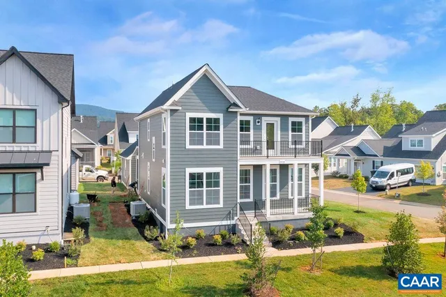 a front view of residential houses with yard and swimming pool