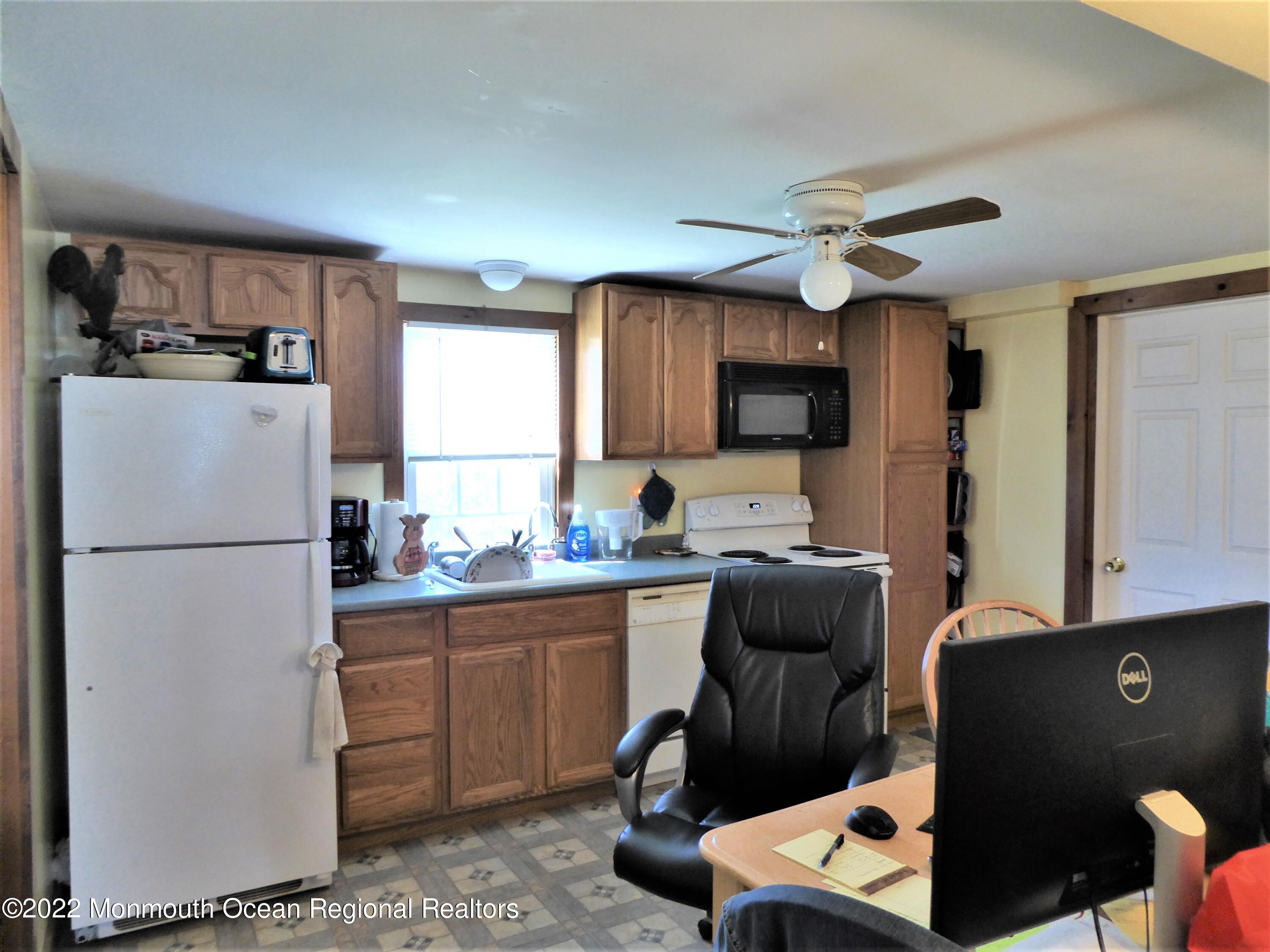 22 Main Street Cream Ridge, NJ 08514 - Photo 12 of 21 a kitchen with a refrigerator and a sink
