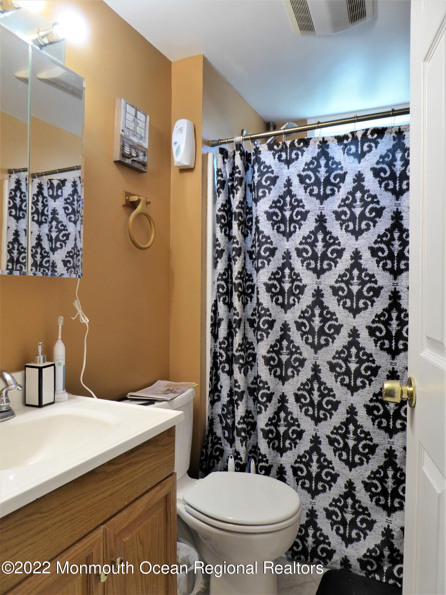 22 Main Street Cream Ridge, NJ 08514 - Photo 17 of 21 a bathroom with a toilet and a shower curtain