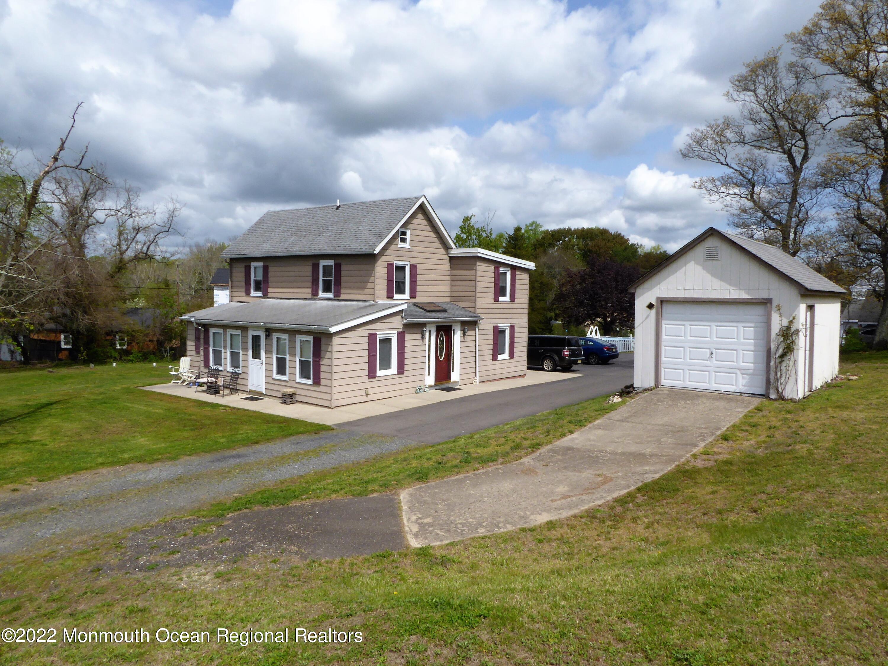 22 Main Street Cream Ridge, NJ 08514 - Photo 3 of 21 a front view of a house with a yard and garage