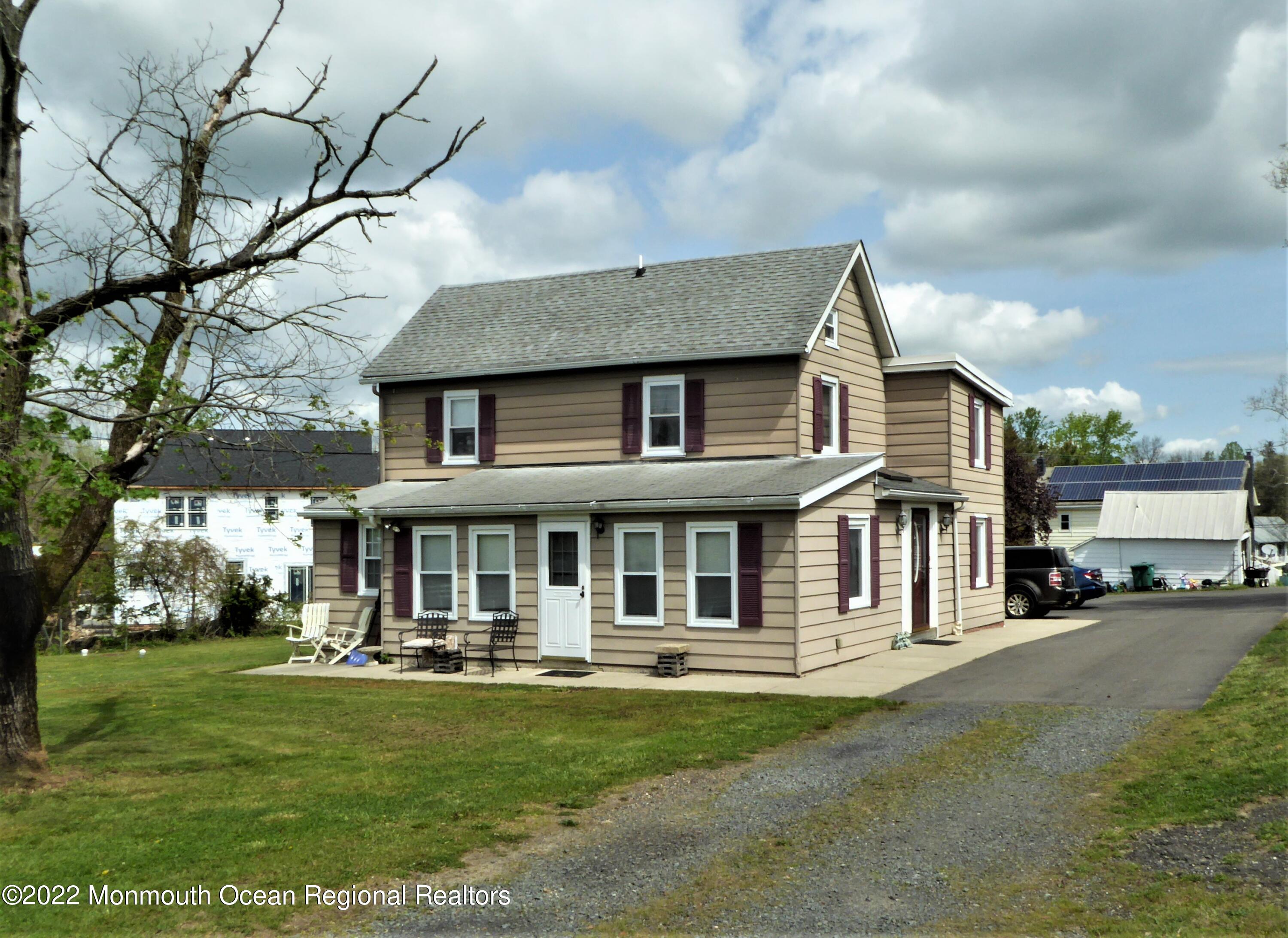 22 Main Street Cream Ridge, NJ 08514 - Photo 5 of 21 a front view of a house with a yard table and chairs