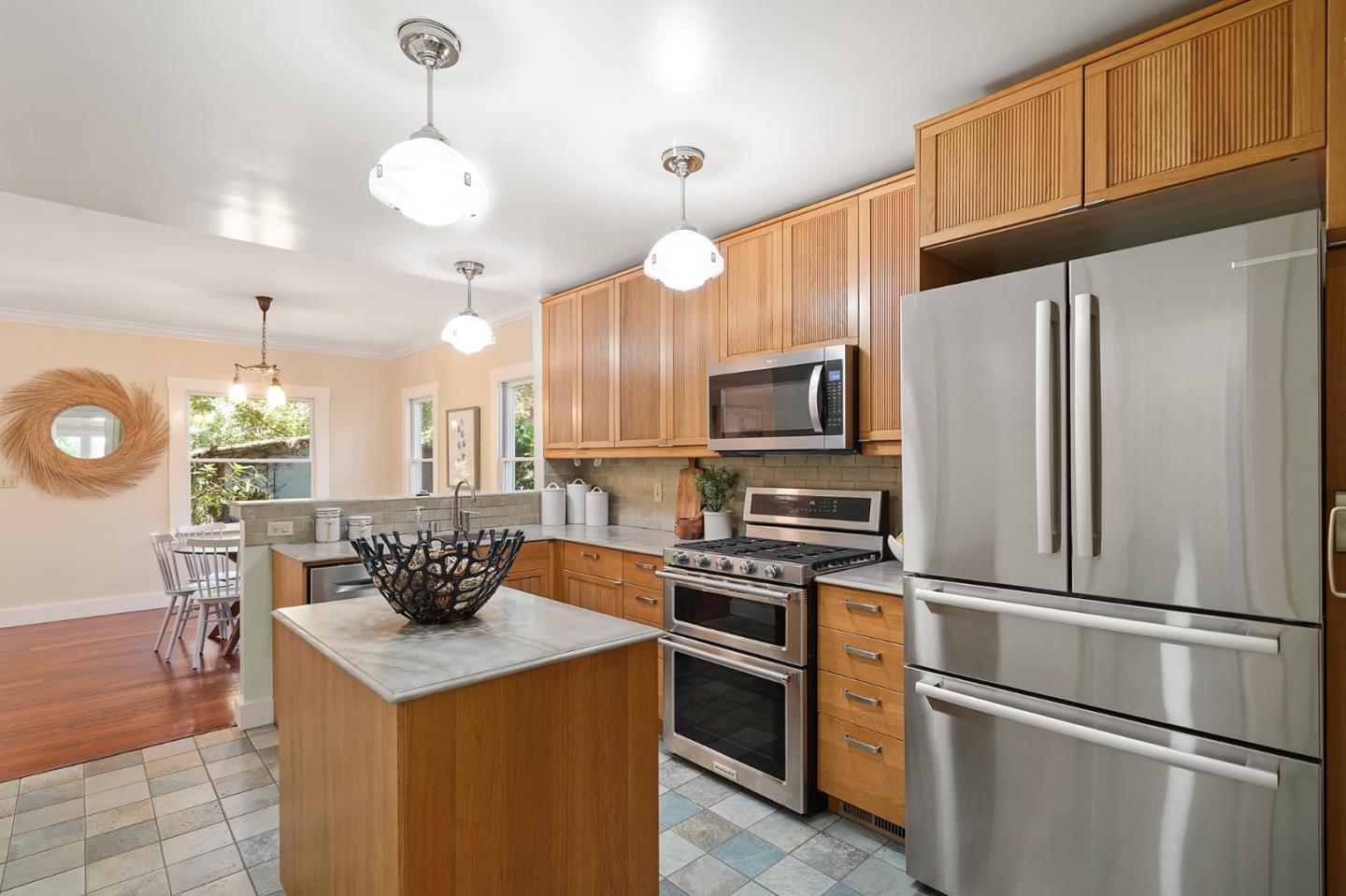 151 Melville Avenue Palo Alto, CA 94301 - Photo 12 of 51 a kitchen with stainless steel appliances granite countertop a refrigerator a stove a sink dishwasher a refrigerator white cabinets and wooden floor