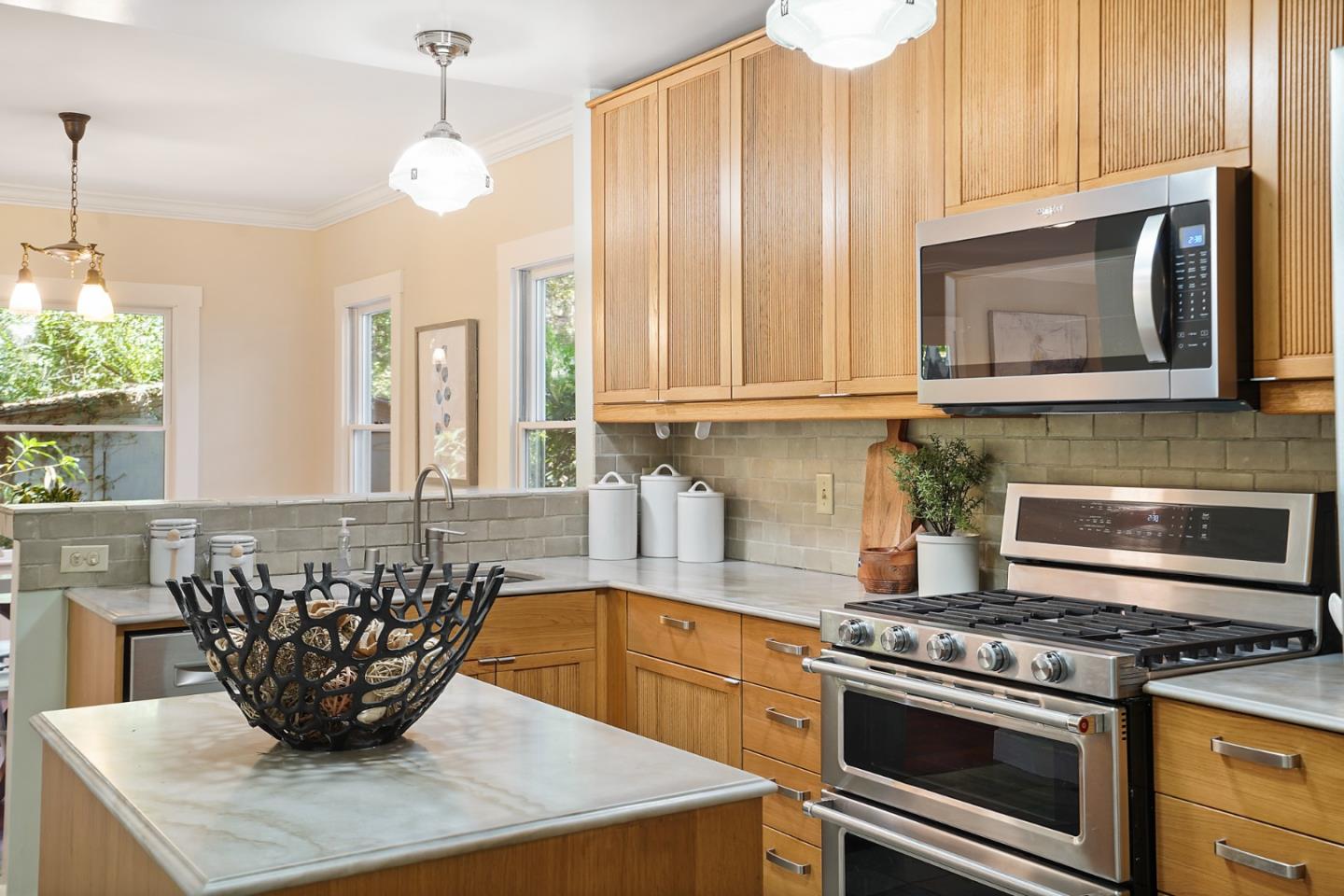 151 Melville Avenue Palo Alto, CA 94301 - Photo 13 of 51 a kitchen with stainless steel appliances granite countertop a stove a sink and a microwave