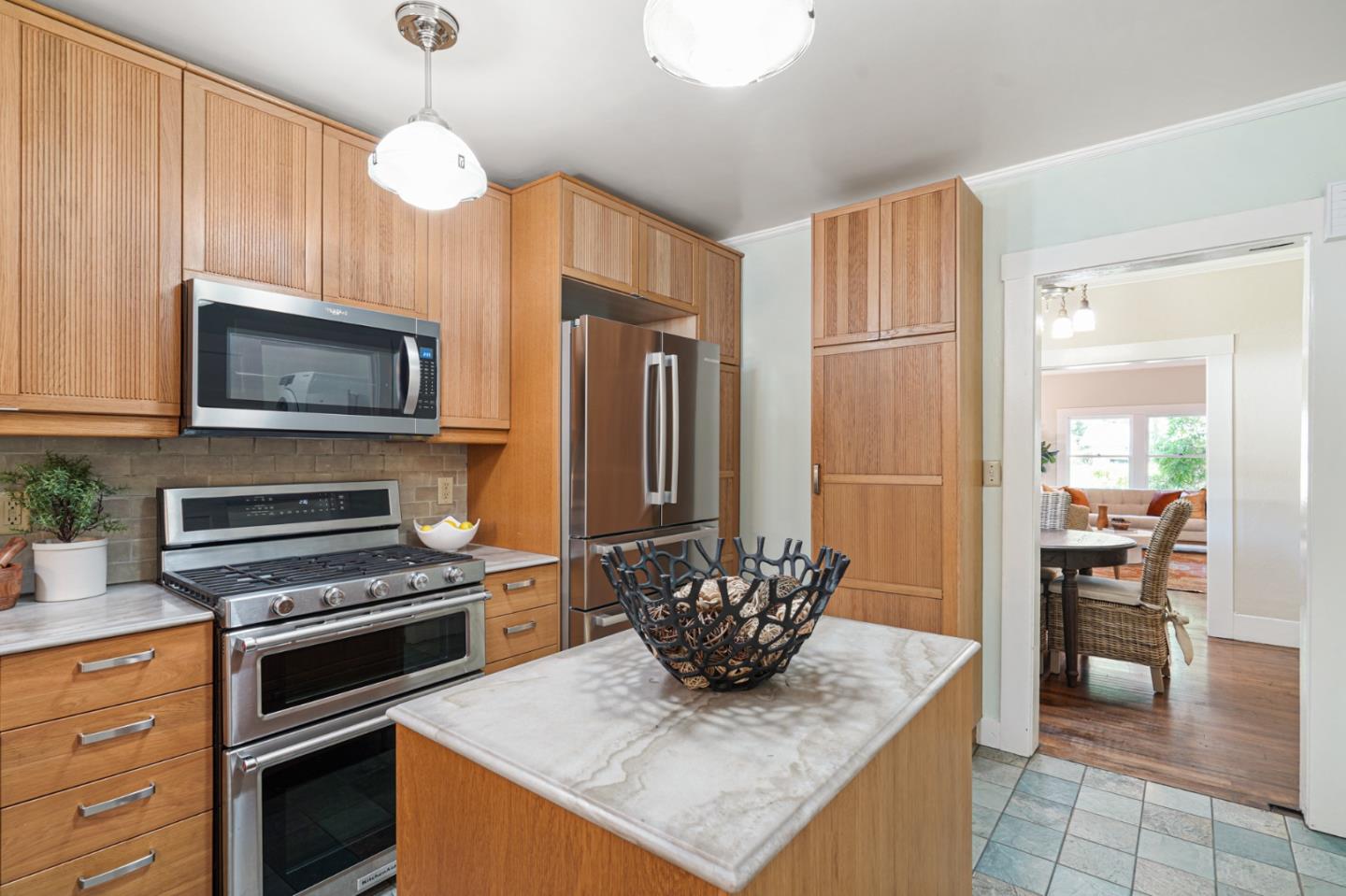151 Melville Avenue Palo Alto, CA 94301 - Photo 14 of 51 a kitchen with stainless steel appliances granite countertop a stove refrigerator and microwave