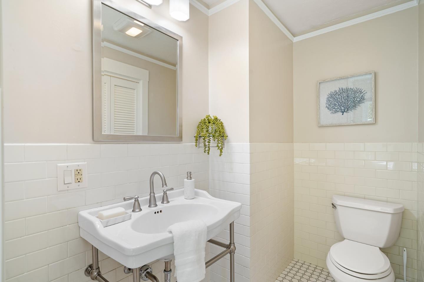 151 Melville Avenue Palo Alto, CA 94301 - Photo 39 of 51 a bathroom with a toilet sink and mirror