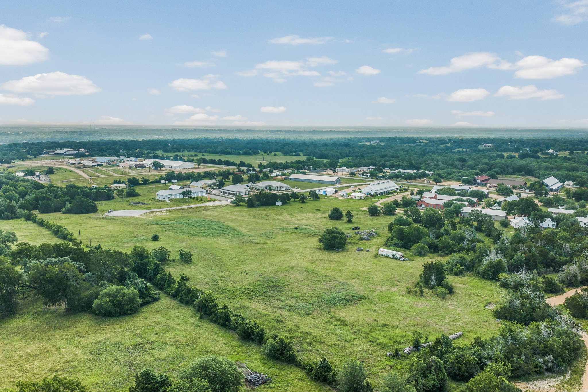 109 Compound Lane Round Top, TX 78954 - Photo 13 of 20 a view of a green field with lots of trees