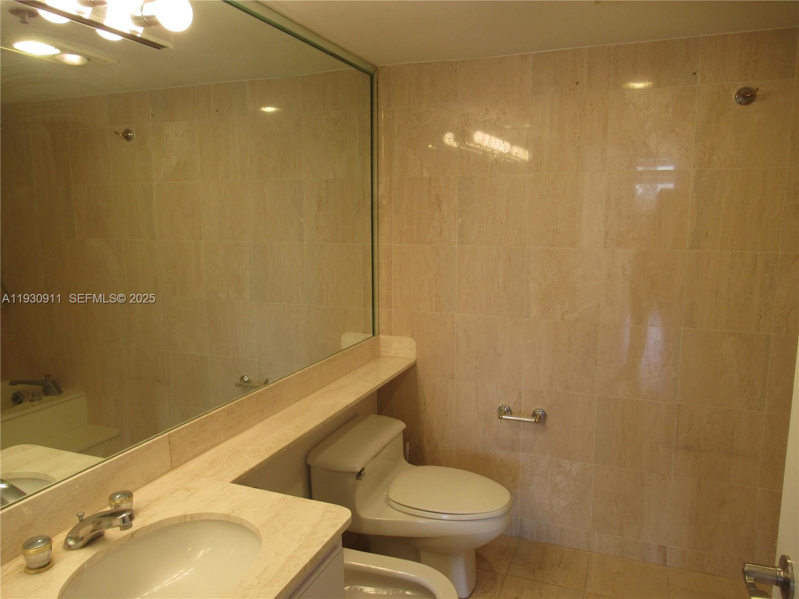 201 Crandon Boulevard, Unit 341 Key Biscayne, FL 33149 - Photo 11 of 25 a bathroom with a sink toilet and shower